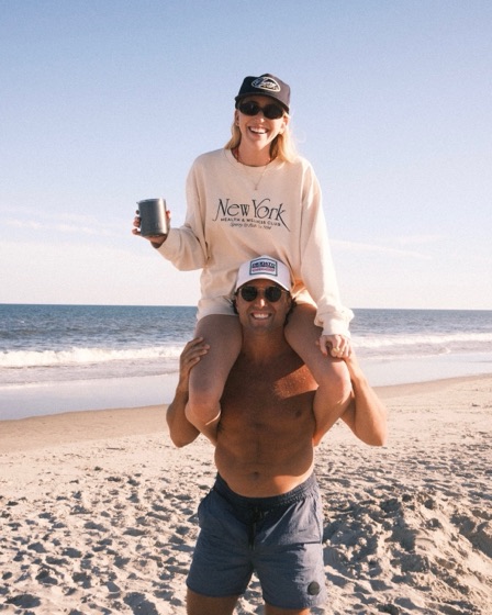 Erin on Nick's shoulders at the beach