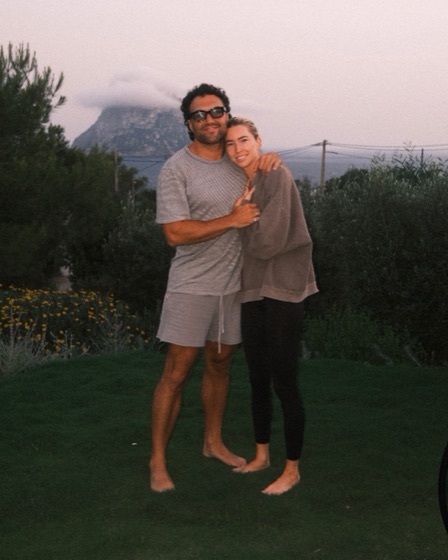 Nick and Erin on a lawn in the hills